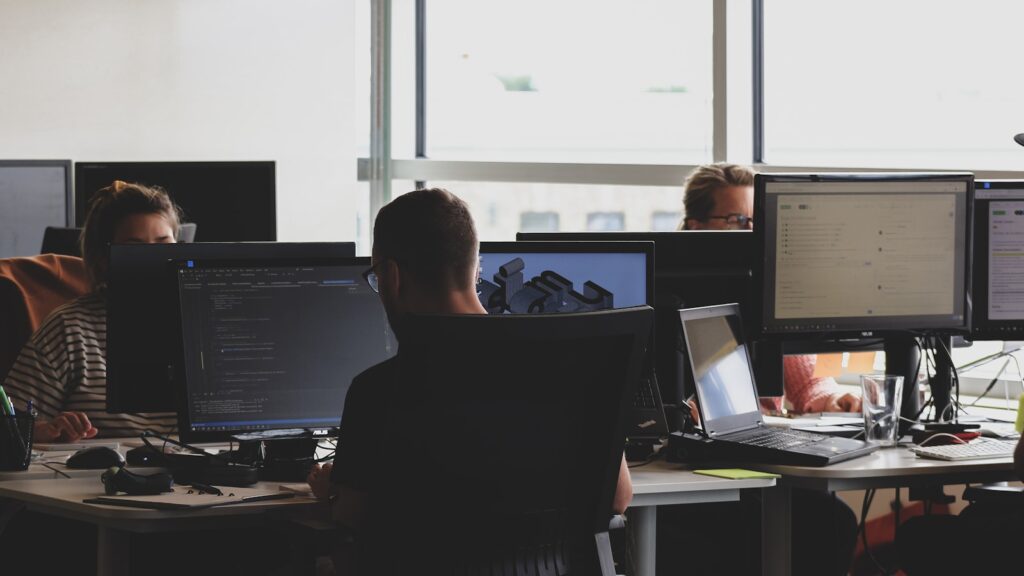 People sitting on chair in front of computer monitor – Understanding the New WordPress Hosting Team AI Policy